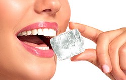 Orange Park patient about to bite into ice with dental implants