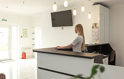 Dental team member standing at front desk