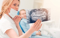 Dentist reviewing an X-ray with patient